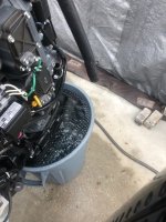 running lower unit in bucket with thermostat exit hose loosened from bottom.jpg